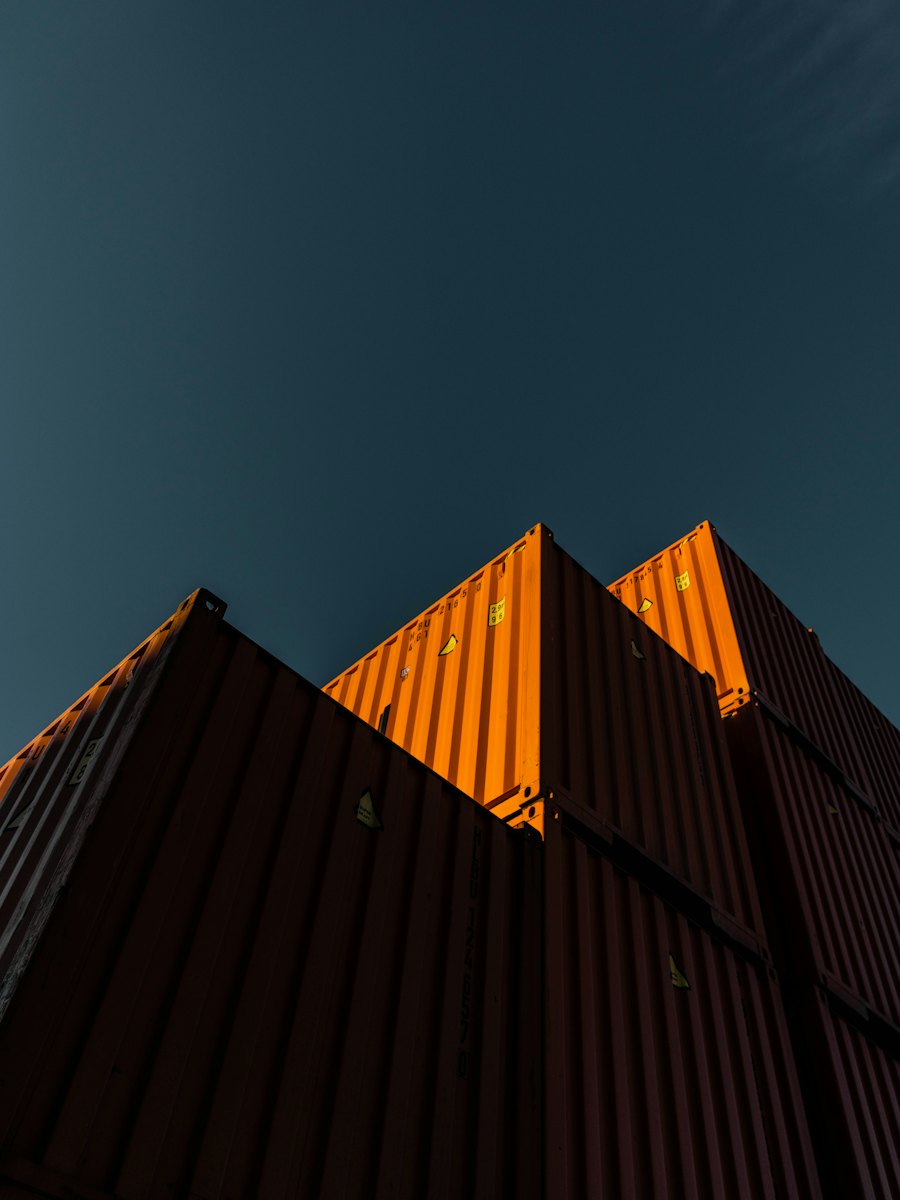 Orange shipping containers against a blue sky